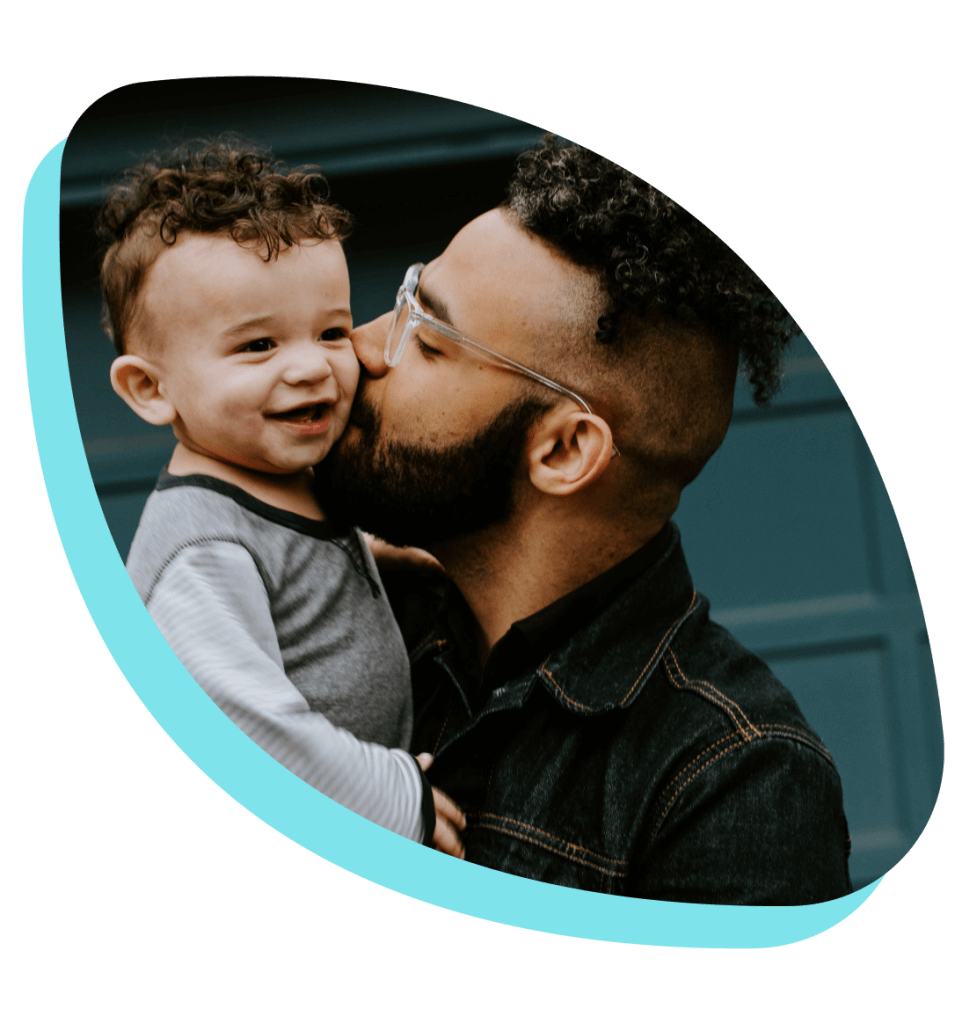 father kissing his son on the cheek