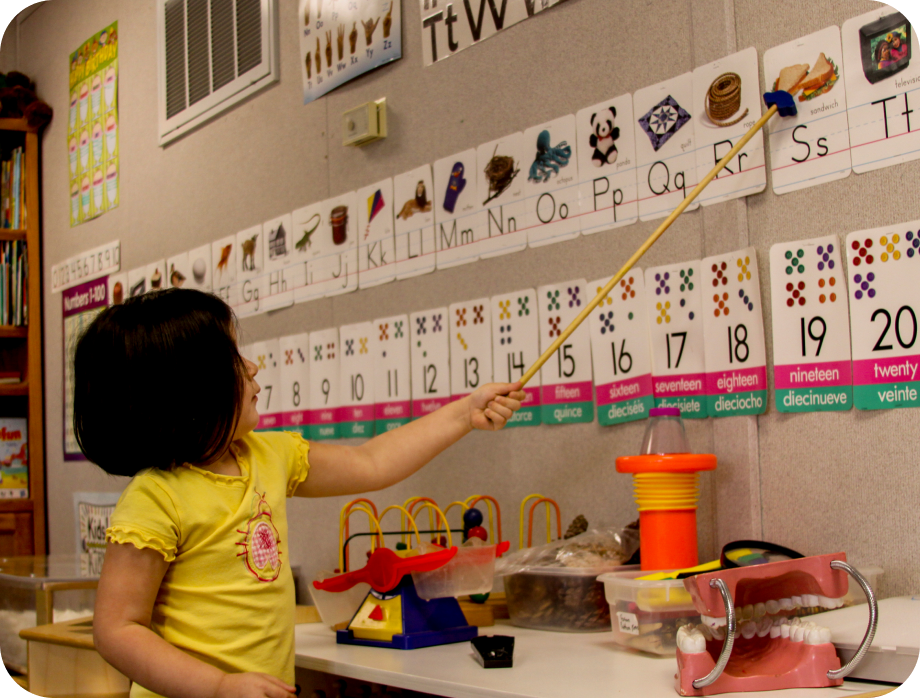 Child learning letters in a classroom